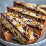 Golden biscotti infused with candied orange peel and dark chocolate chunks, ideal for dipping into espresso or sweet dessert wine.  