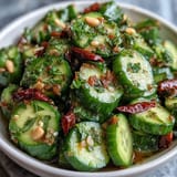 Crispy smashed cucumbers tossed in tangy garlic chili oil for a refreshing, spicy salad.