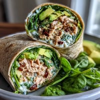 Fresh avocado tuna wraps with baby spinach and whole wheat tortillas, perfect for quick healthy lunches.